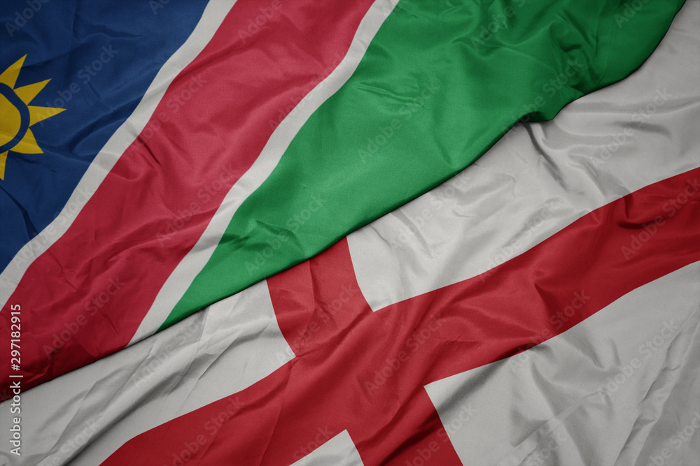 waving colorful flag of england and national flag of namibia.