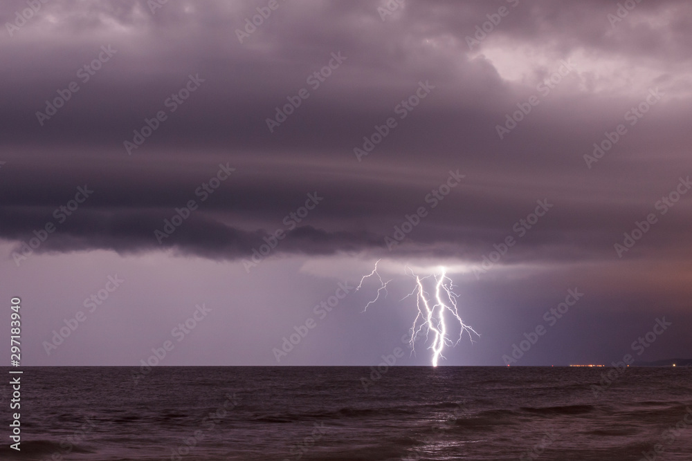 storm cloud and lightning over sea