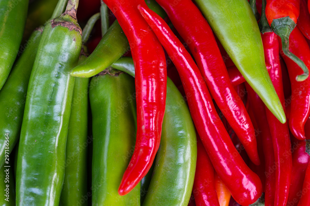 A pile of red and green chili peppers - Capsicum annuum – to be used as a food ingredient.