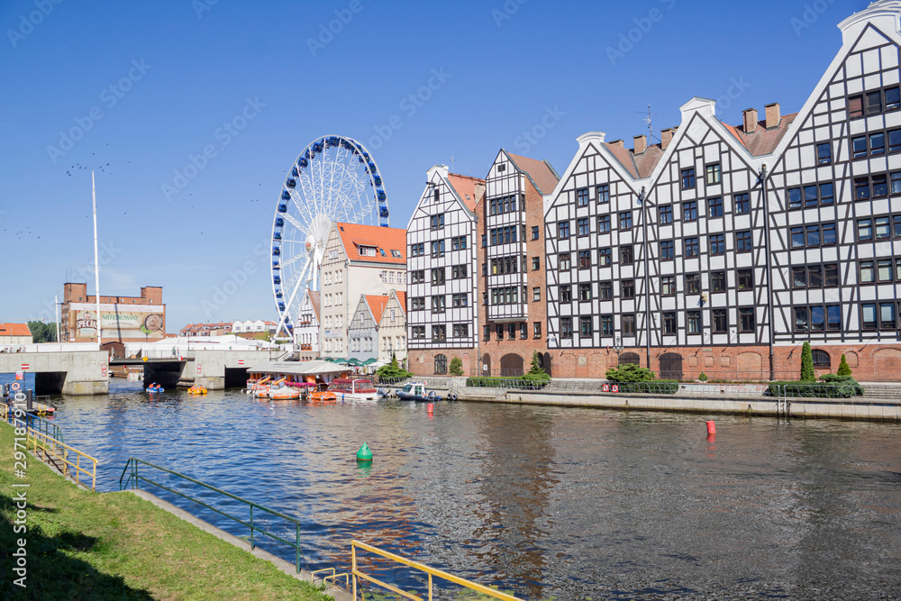 Gdansk, Poland. Ferris wheel with architecture and River Motława in old city.