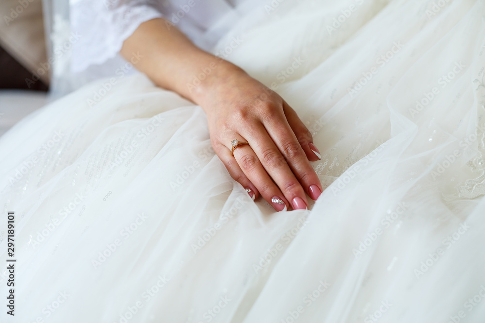 the bride holds in her hands a beautiful wedding dress the bride holds in her hands a beautiful wedding dress