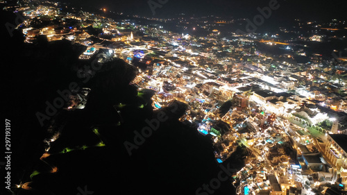 Aerial night shot of iconic village of Fira built on top of cliff, Santorini island, Cyclades, Greece