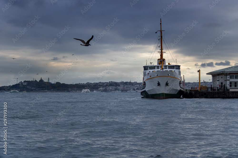 Fototapeta premium In Istanbul, ferries operate on the Bosphorus line. Traditional old steamers. Cloud weather in the background.
