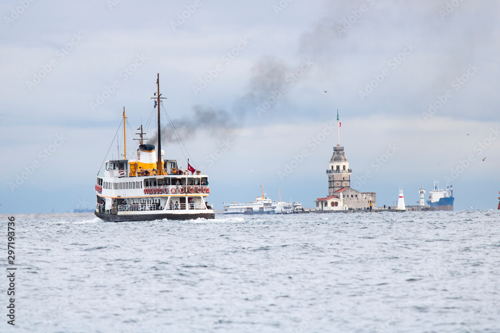 In Istanbul, ferries operate on the Bosphorus line. Traditional old steamers. Cloud weather in the background and the Anatolian side.