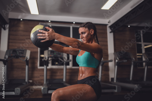Fit girl in the gym with medicine ball