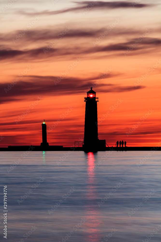 silhouetted lighthouse at sunset