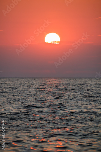 Fototapeta Naklejka Na Ścianę i Meble -  sunset into clouds over sea