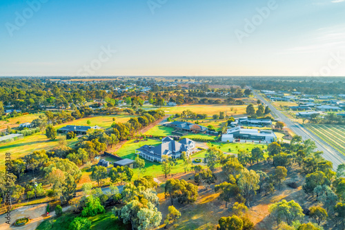 Countryside houses and agricultural land at sunset - aerial view