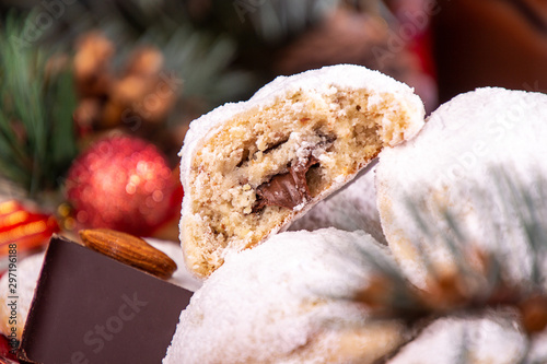 Traditional Christmas cookies biscuits snowballs covered icing sugar povder with almond nut, nutella chocolate an raspberry jam. Christmas New Year ornament decorations. photo