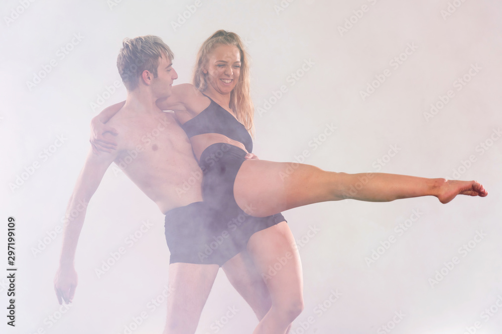 Two Young modern dancers dancing in the studio. Sport, dancing and urban culture concept. Group of young dancers performing on the stage. Effective performance.  full of energe dancers.