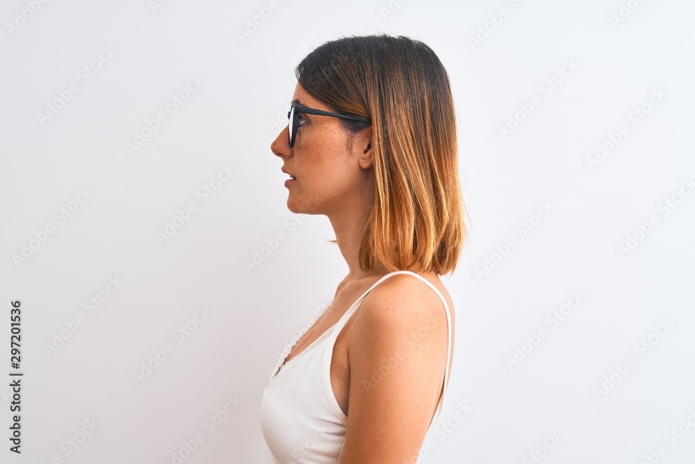 Beautiful redhead woman wearing glasses over isolated background looking to side, relax profile pose with natural face with confident smile. Beautiful redhead woman wearing glasses over isolated background looking to side, relax profile pose with natural face with confident smile.