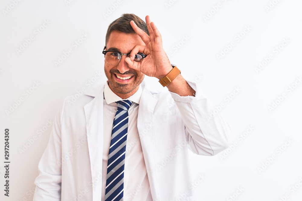 Young handsome therapist man over isolated background doing ok gesture with hand smiling, eye looking through fingers with happy face. Young handsome therapist man over isolated background doing ok gesture with hand smiling, eye looking through fingers with happy face.
