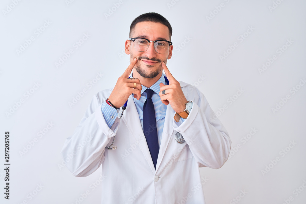 Young doctor man wearing stethoscope over isolated background Smiling with open mouth, fingers pointing and forcing cheerful smile Young doctor man wearing stethoscope over isolated background Smiling with open mouth, fingers pointing and forcing cheerful smile