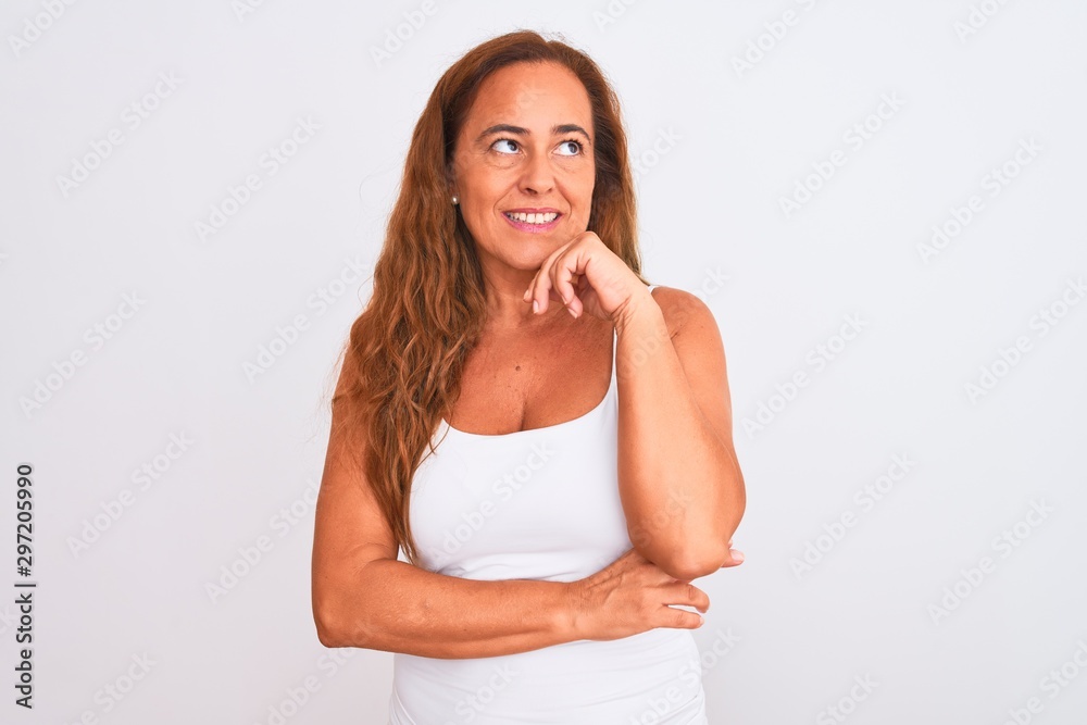 Middle age mature woman standing over white isolated background with hand on chin thinking about question, pensive expression. Smiling and thoughtful face. Doubt concept. Middle age mature woman standing over white isolated background with hand on chin thinking about question, pensive expression. Smiling and thoughtful face. Doubt concept.