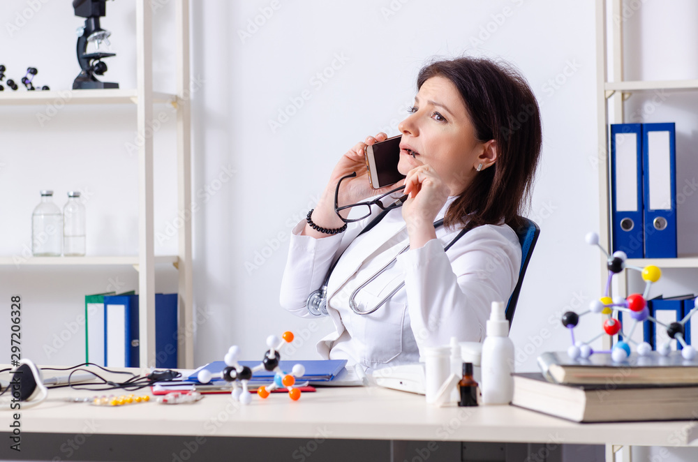 Middle-aged female doctor in telemedicine concept Middle-aged female doctor in telemedicine concept