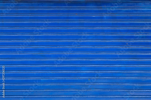 blue rolling metal door, horizontal striped background