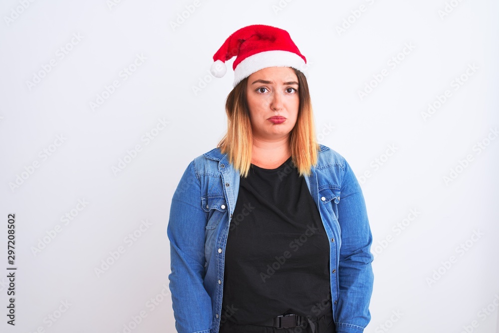 Young beautiful woman wearing Christmas Santa hat standing over isolated white background depressed and worry for distress, crying angry and afraid. Sad expression. Young beautiful woman wearing Christmas Santa hat standing over isolated white background depressed and worry for distress, crying angry and afraid. Sad expression.