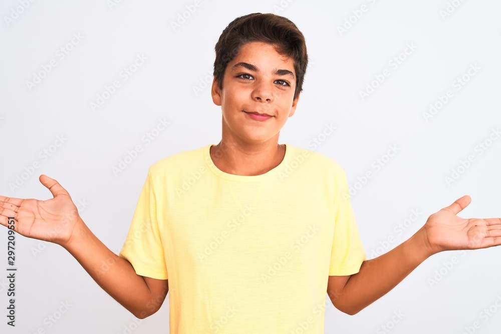 Handsome teenager boy standing over white isolated background clueless and confused expression with arms and hands raised. Doubt concept. Handsome teenager boy standing over white isolated background clueless and confused expression with arms and hands raised. Doubt concept.