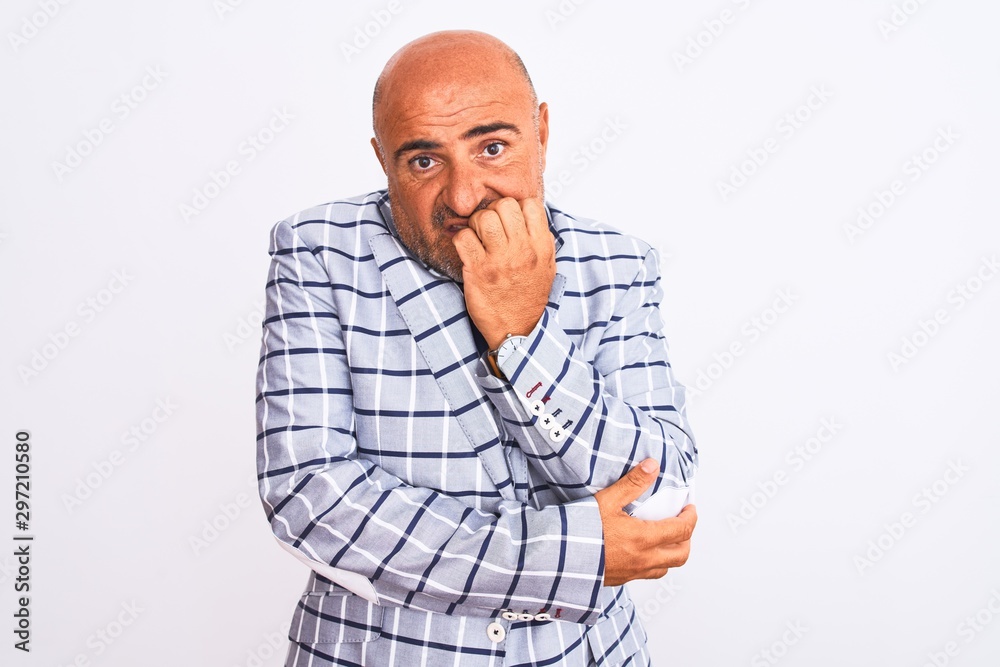 Fototapeta premium Middle age businessman wearing suit standing over isolated white background looking stressed and nervous with hands on mouth biting nails. Anxiety problem.