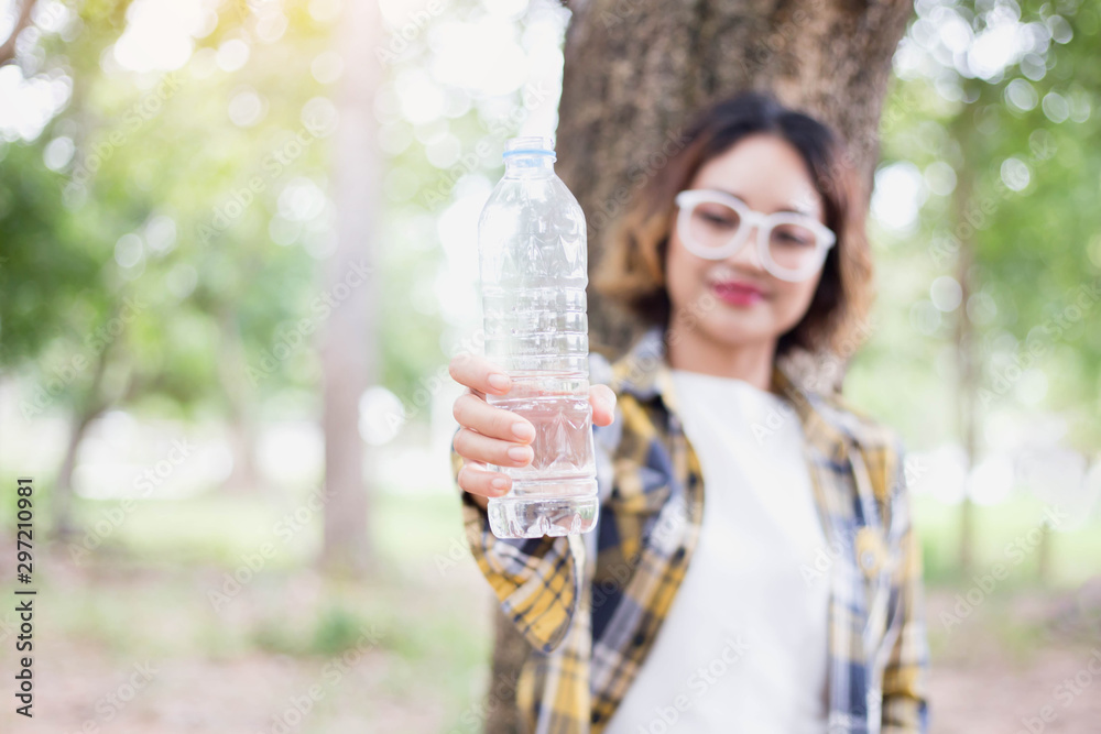 Girl drinking water from bottle in forrest Girl drinking water from bottle in forrest