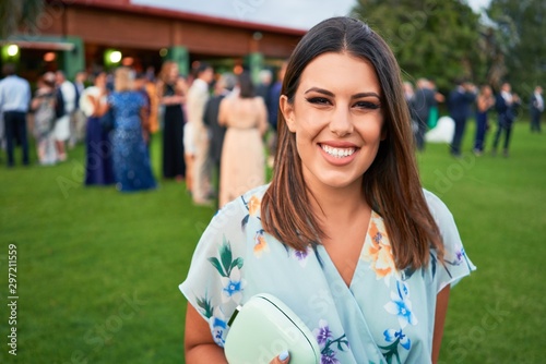 Photography Young beautiful and elegant woman with wedding guest dress smiling happy and che