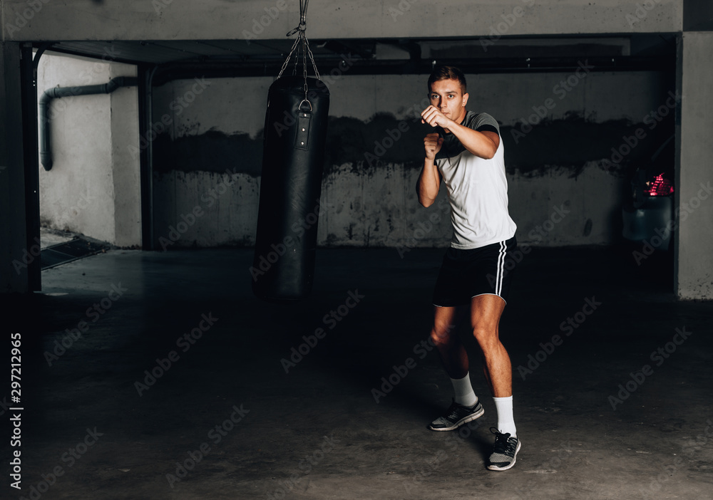 Young muscular sports guy practicing boxing Young muscular sports guy practicing boxing