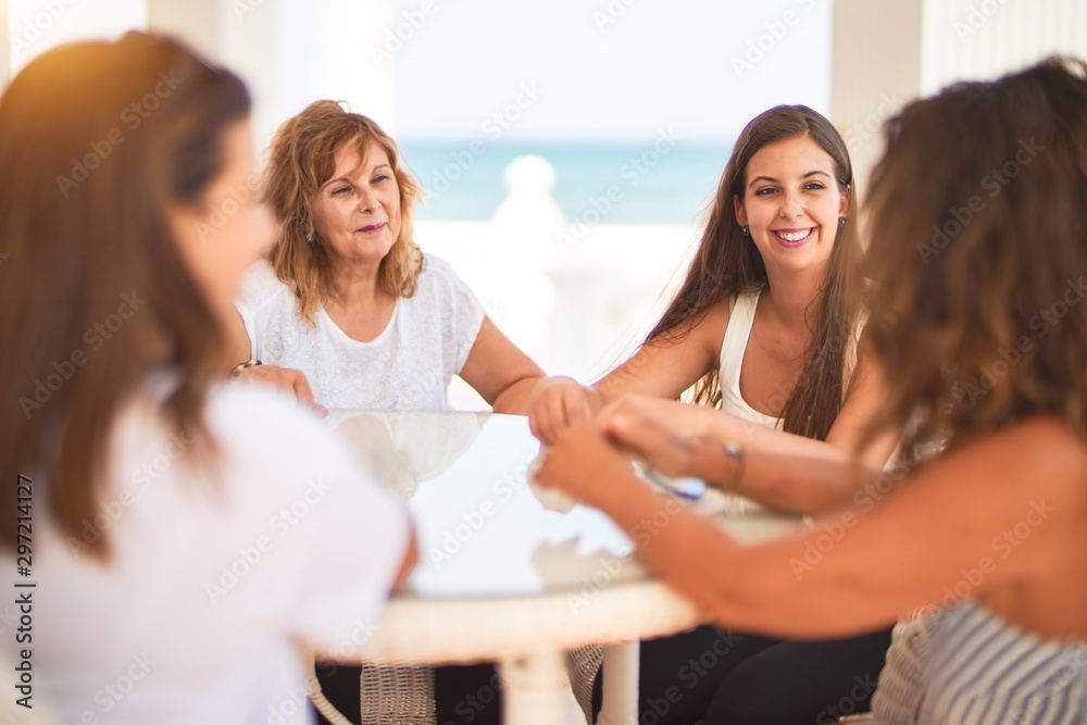 Beautiful group of women sitting at terrace speaking and smiling Beautiful group of women sitting at terrace speaking and smiling