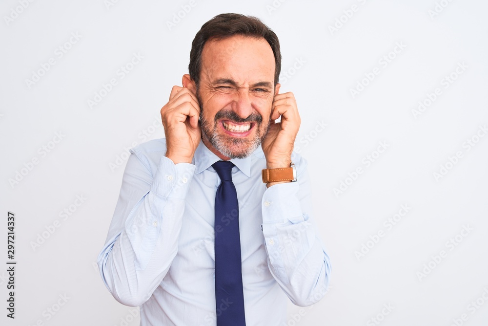 Middle age businessman wearing elegant tie standing over isolated white background covering ears with fingers with annoyed expression for the noise of loud music. Deaf concept.