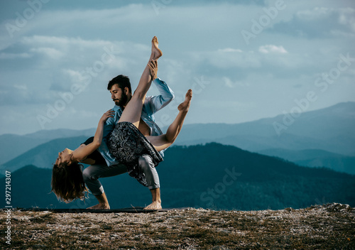 Two modern dancers practicing dancing on the mountain cliff
