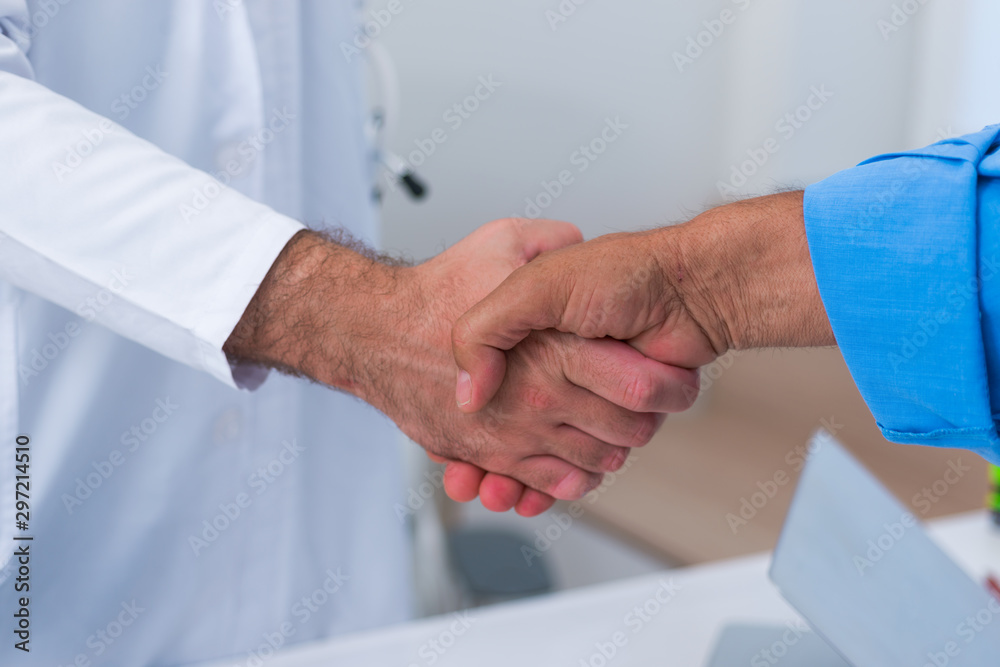 Handshake between a doctor and his senior ( old ) patient. Handshake between a doctor and his senior ( old ) patient.