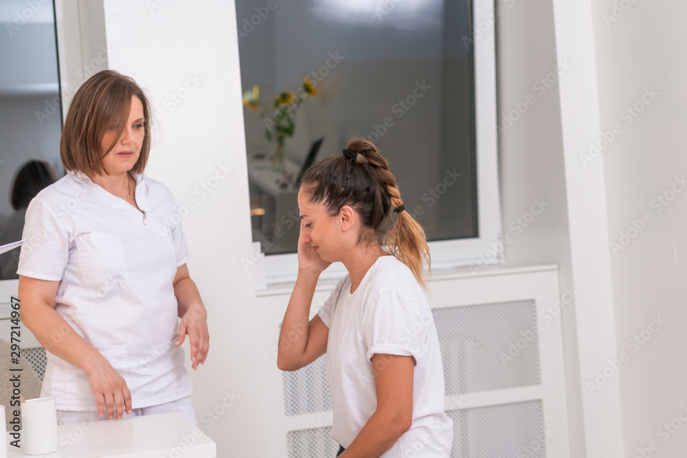 Doctor checking patients ear during medical examination Doctor checking patients ear during medical examination