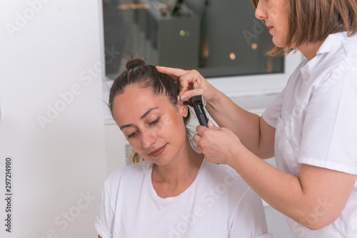 Doctor checking patients ear during medical examination