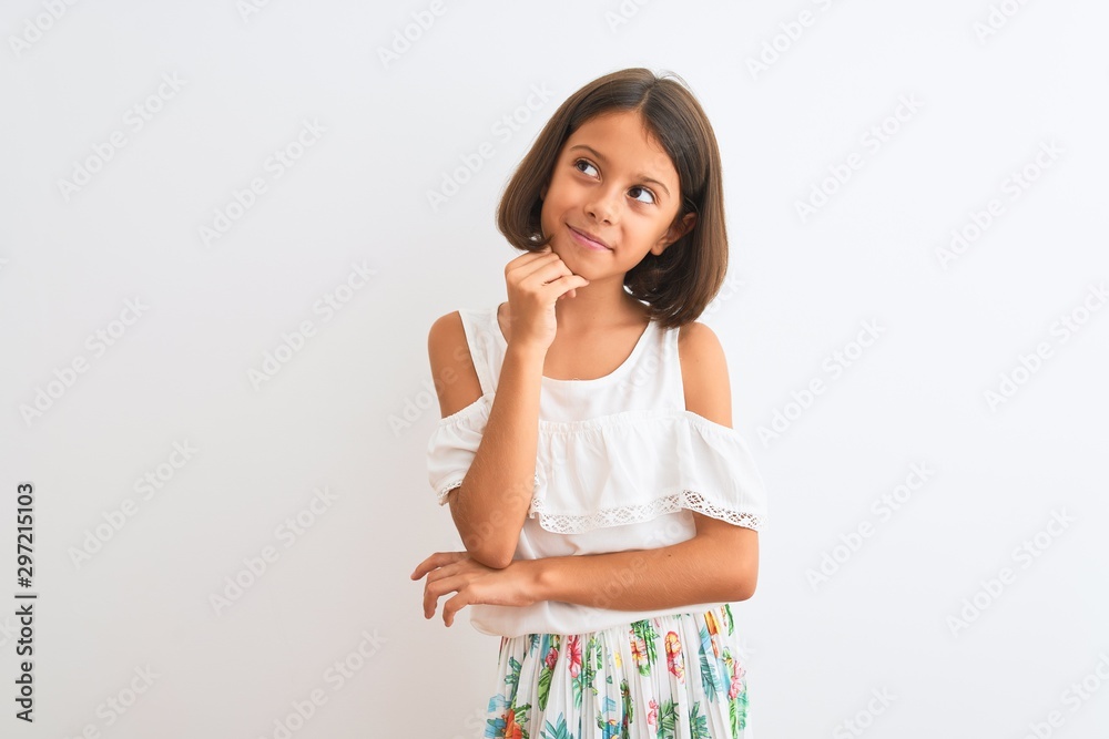 Young beautiful child girl wearing casual dress standing over isolated white background with hand on chin thinking about question, pensive expression. Smiling with thoughtful face. Doubt concept. Young beautiful child girl wearing casual dress standing over isolated white background with hand on chin thinking about question, pensive expression. Smiling with thoughtful face. Doubt concept.