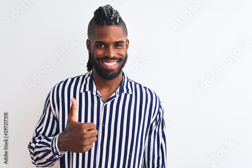 African american man with braids wearing striped shirt over isolated white background doing happy thumbs up gesture with hand. Approving expression looking at the camera with showing success.