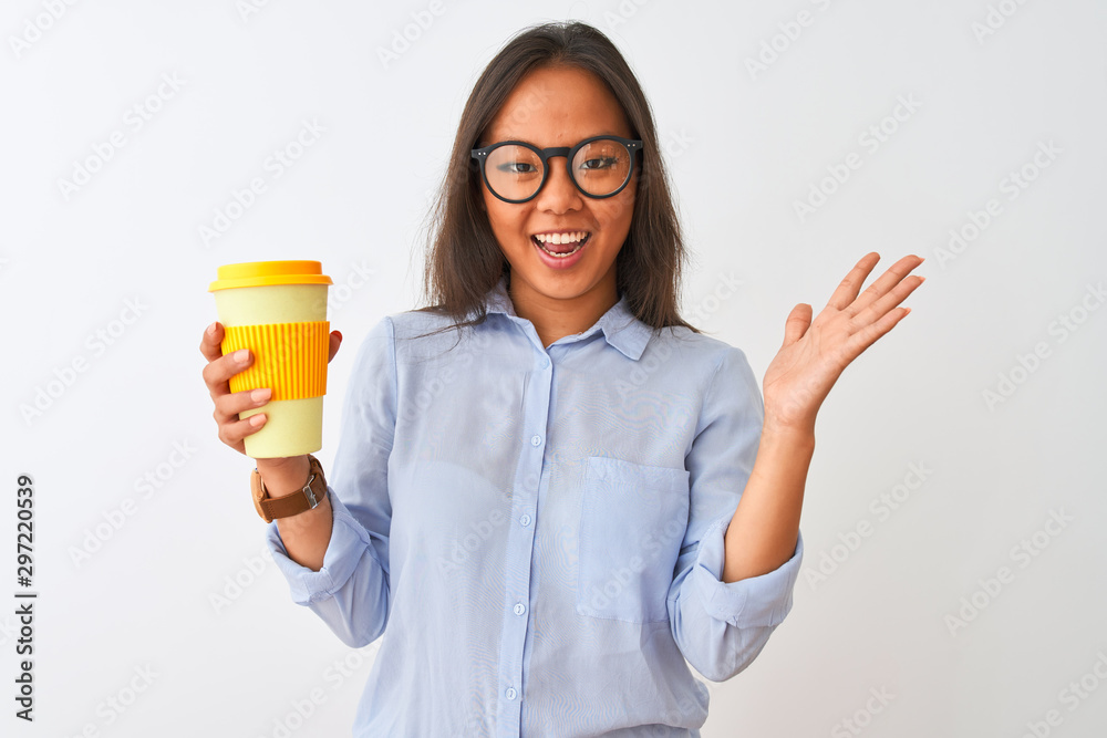 Young chinese woman wearing glasses holding glass of coffee over isolated white background very happy and excited, winner expression celebrating victory screaming with big smile and raised hands Young chinese woman wearing glasses holding glass of coffee over isolated white background very happy and excited, winner expression celebrating victory screaming with big smile and raised hands