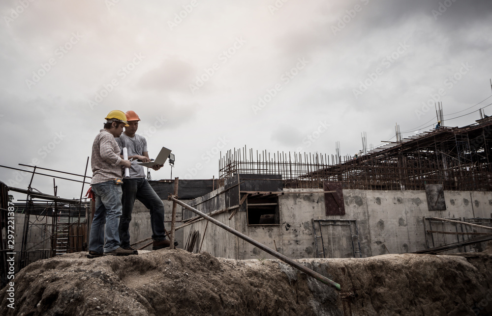 Architect and engineer discuss in building construction site.