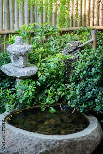 Japanese style garden With water flowing out of the bamboo into a small basin