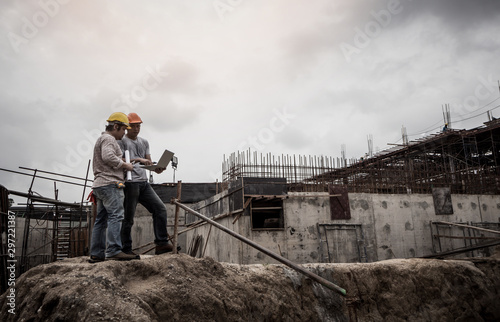 Architect and engineer discuss in building construction site.