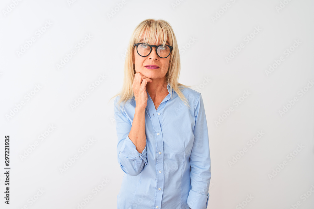 Middle age businesswoman wearing elegant shirt and glasses over isolated white background with hand on chin thinking about question, pensive expression. Smiling with thoughtful face. Doubt concept.