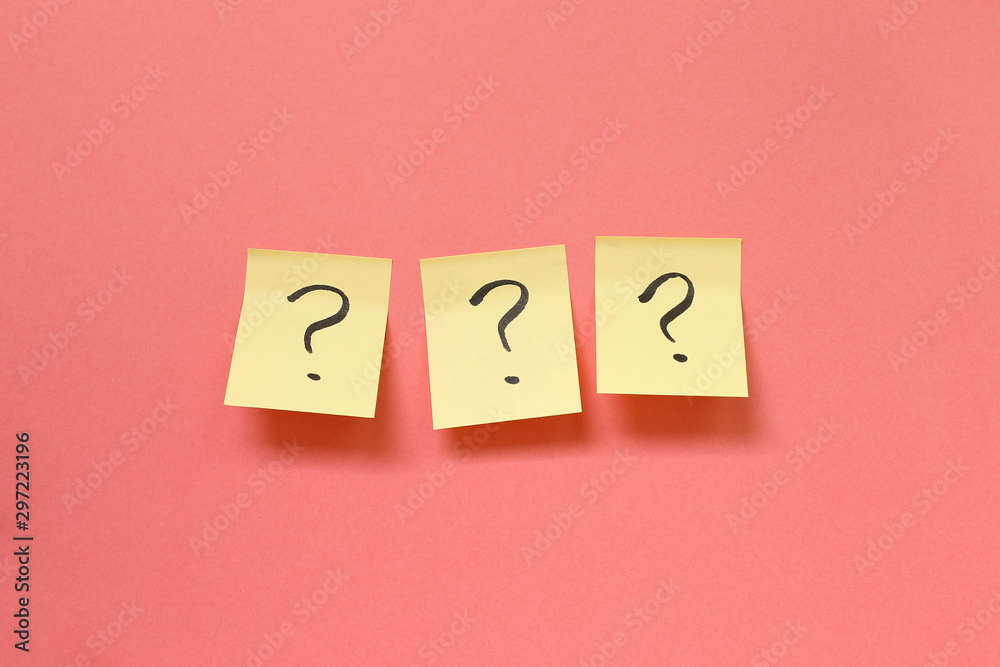 Question mark on memo paper on pink background. Solution concept