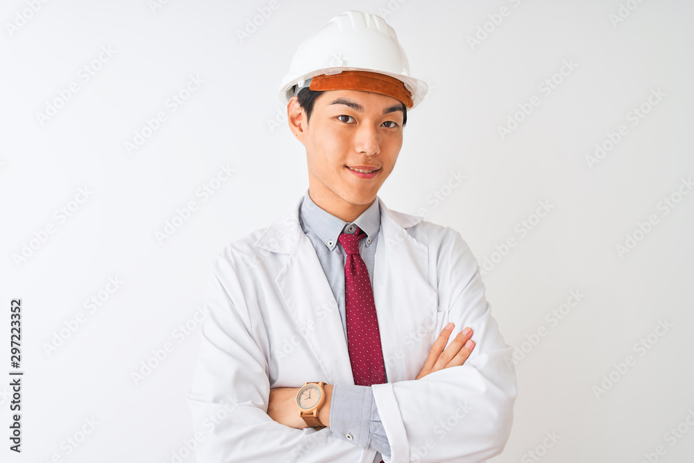 Chinese architect man wearing coat and helmet standing over isolated white background happy face smiling with crossed arms looking at the camera. Positive person. Chinese architect man wearing coat and helmet standing over isolated white background happy face smiling with crossed arms looking at the camera. Positive person.