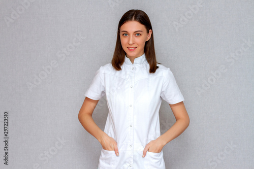 Girl doctor in a white coat, young woman doctor