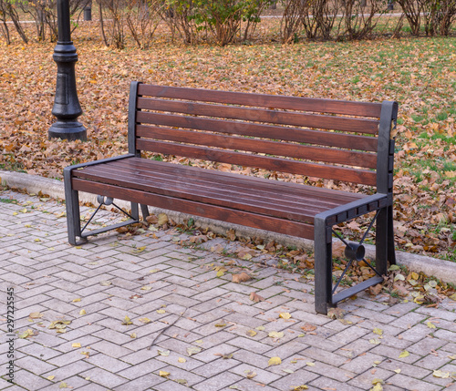 old wooden bench in a quiet autumn city part park. background, nature.