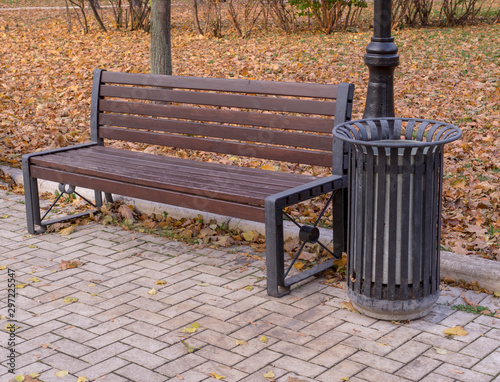 old wooden bench in a quiet autumn city part park. background, nature.