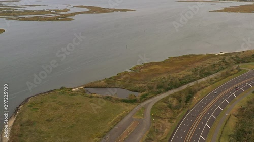 Wallpaper Mural dolly shot forward of a drone camera on a cloudy day, then the camera tilts down to view marshland shoreline & vegetation Torontodigital.ca