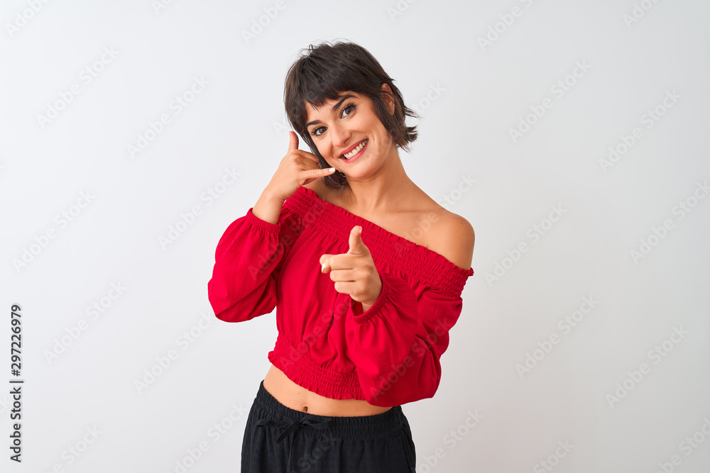 Young beautiful woman wearing red summer t-shirt standing over isolated white background smiling doing talking on the telephone gesture and pointing to you. Call me. Young beautiful woman wearing red summer t-shirt standing over isolated white background smiling doing talking on the telephone gesture and pointing to you. Call me.