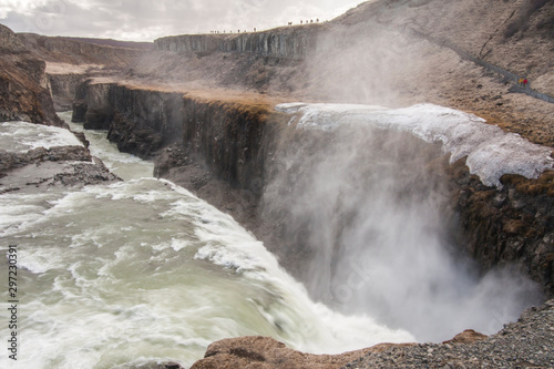 Fototapeta Naklejka Na Ścianę i Meble -  A three-step staircase of the Gullfoss waterfall on Hvita river, as pictured in detail (water plunging into the canyon, mossy cliffs, thick spray, panorama of the rapids)
