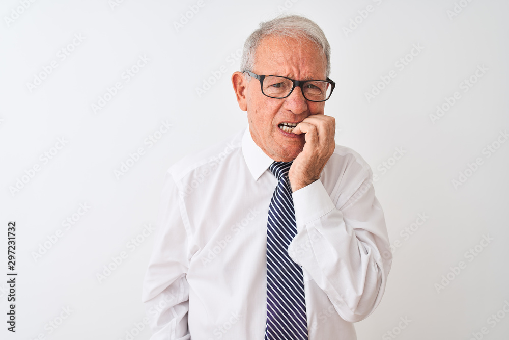 Senior grey-haired businessman wearing tie and glasses over isolated white background looking stressed and nervous with hands on mouth biting nails. Anxiety problem. Senior grey-haired businessman wearing tie and glasses over isolated white background looking stressed and nervous with hands on mouth biting nails. Anxiety problem.