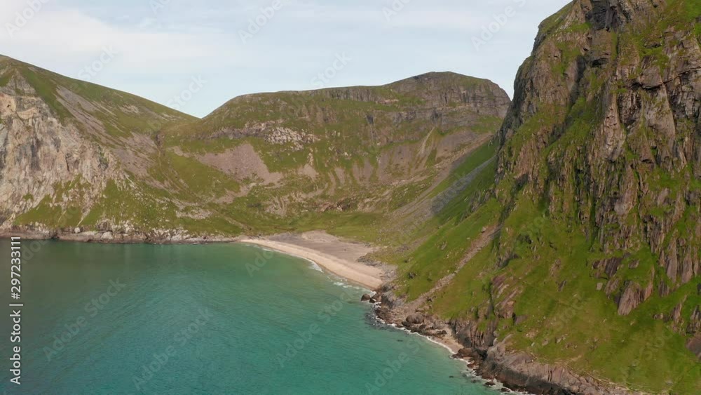 Aerial shot of remote Lofoten Sandvika beach in Noway surrounded by steep cliffs Aerial shot of remote Lofoten Sandvika beach in Noway surrounded by steep cliffs