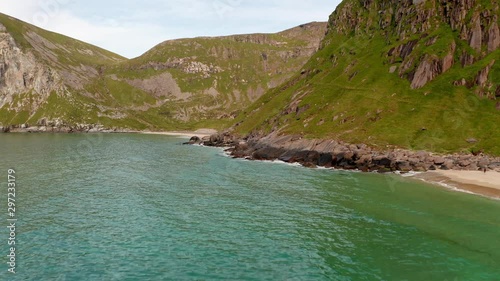 Aerial shot of remote Lofoten Sandvika beach in Noway surrounded by steep cliffs photo